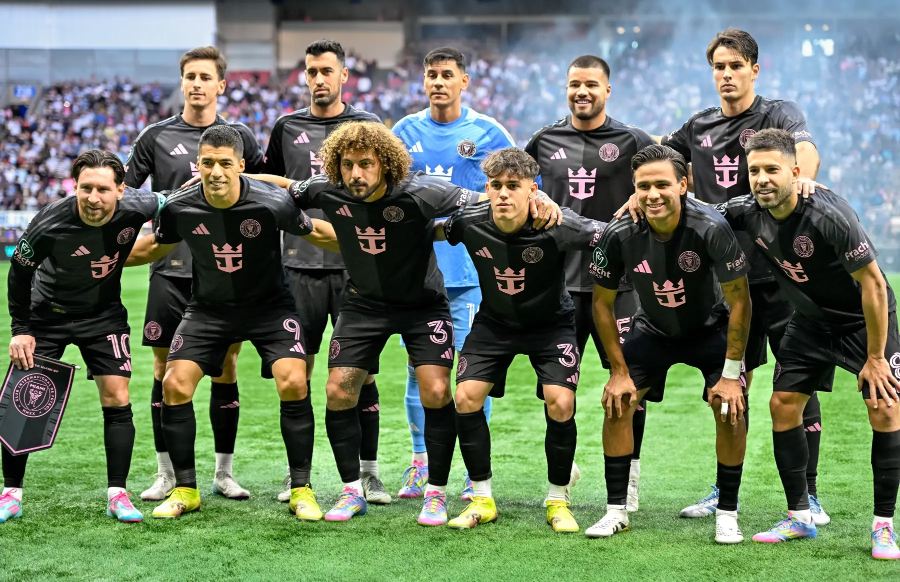 Soccer team posing together on the field