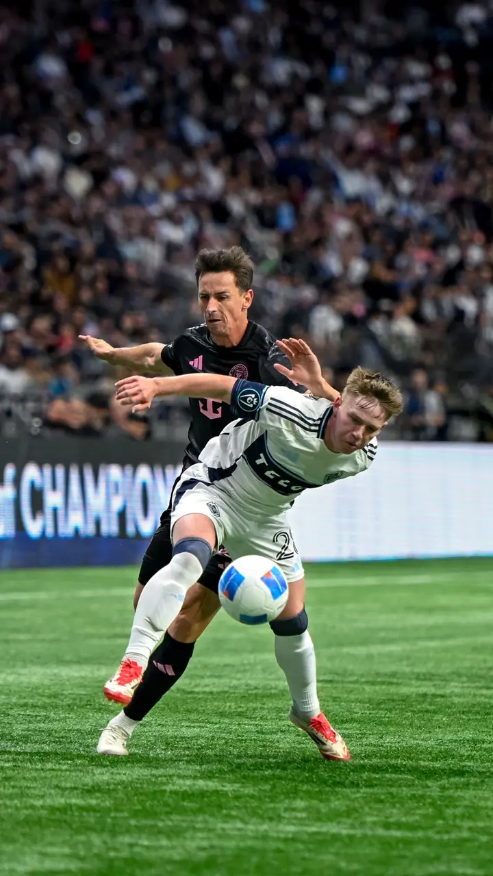 Professional soccer players competing during a match