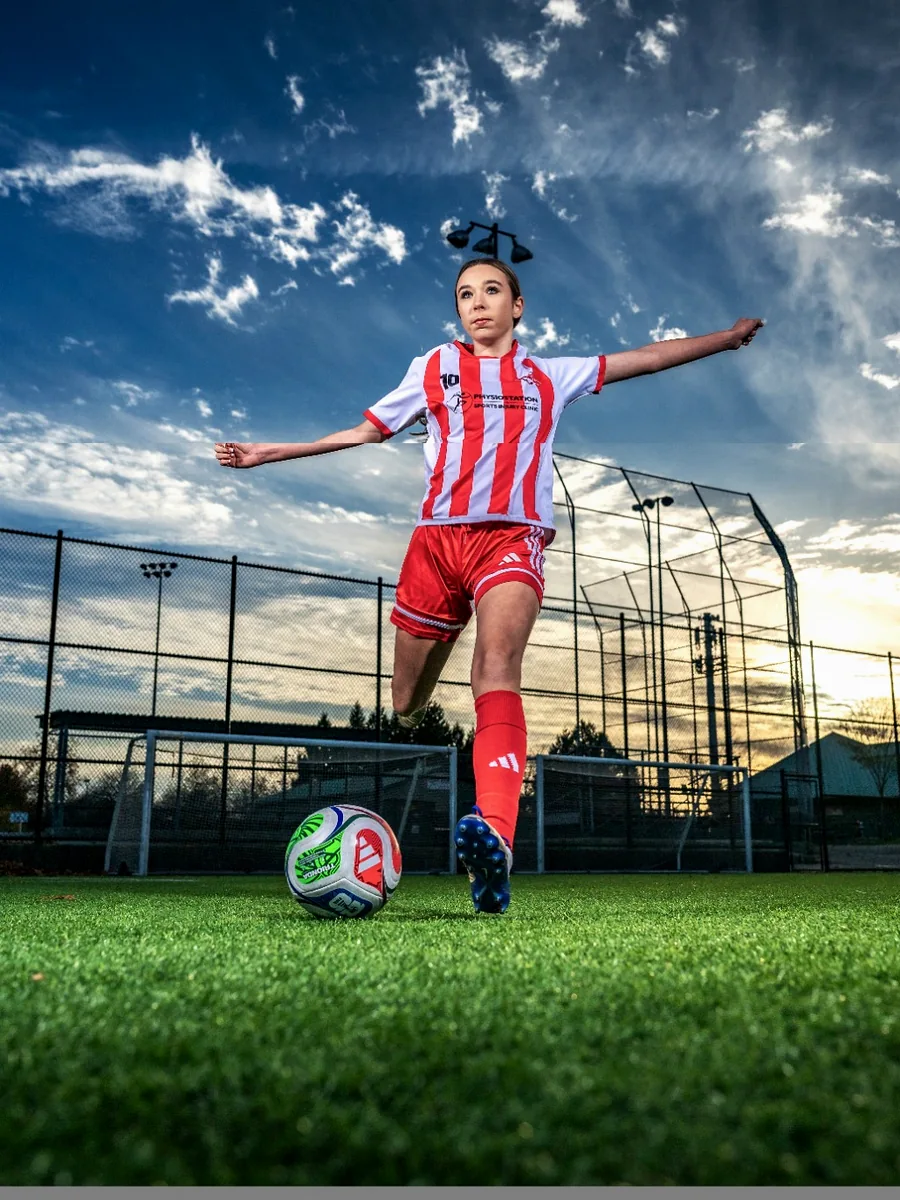 Female soccer athlete photographed in action