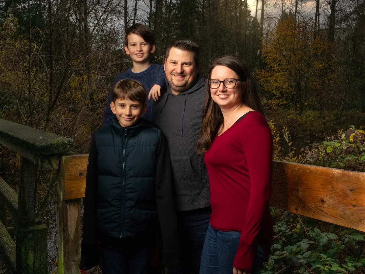 Family gathered together on a wooded trail