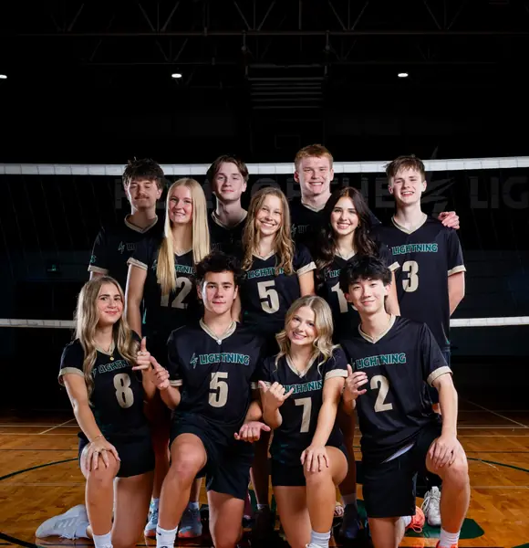 Volleyball team photographed inside a gymnasium