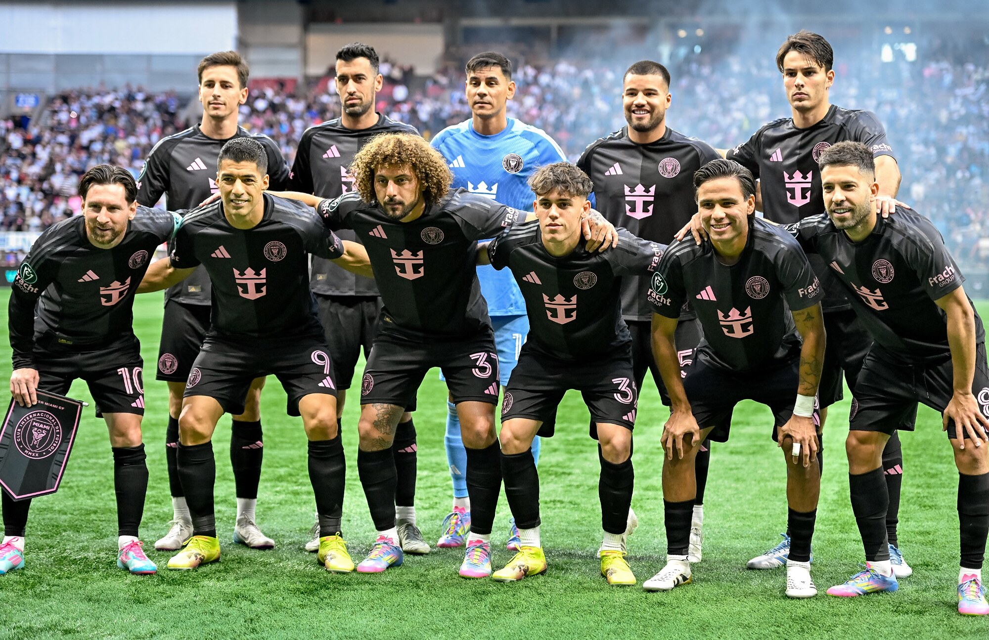 Professional soccer club posing together before a match