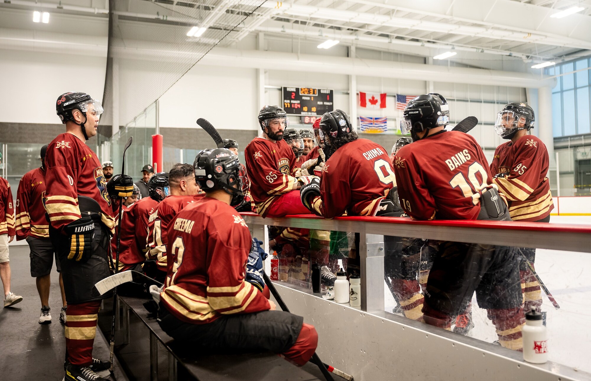 Hockey team gathered at the bench during an event